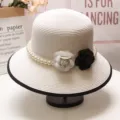 Elegant white straw sun hat detail featuring exquisite pearl beads and double camellia flowers. - M (56-58cm) Adjustable / White