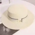 Summer flat top straw hat for women, elegant beach sun hat with metal M logo and ribbon. - One Size / Milky White