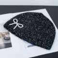 Black sequin knit beanie with elegant pearl bow, stylish winter warm hat fashion accessory. - Artificial Pearl Bow Style