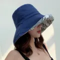Close-up detail of the stylish double-sided bucket hat featuring floral inner brim design. - Adjustable / Navy Blue