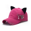 Detailed view of punk style pink baseball cap featuring cute black cat ears and metal rings. - Adjustable / Blade / Rose Red