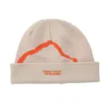 Detail view of beige knit beanie featuring orange mountain embroidery and brand text. - One Size / Beige