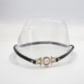 Close-up detail of a black leather hat band accessory featuring an elegant gold pearl buckle. - Black Slim Faux Leather Band With Gold Artificial Pearl Decorative Buckle