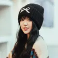 Women winter knit beanie hat with cute white bow, cozy warm knitted cap for cold weather fashion. - One Size / Black