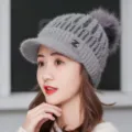 Detailed view of women winter thick fleece knit hat with pom-pom and metal logo warm cap. - One Size / Gray Single Hat