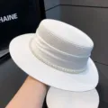 Elegant white straw boater hat with satin ribbon and pearl trim for women summer sun protection. - 7cm Brim / White