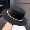 Elegant black straw boater hat featuring a chic pearl band and ribbon. Perfect for summer. - 7cm Brim / Black
