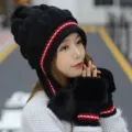 Close-up detail showing an Asian model wearing a black winter knitted hat and matching gloves - Set / One Size Stretchy / Black