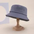 Detail view of a classic grey cotton bucket hat, casual sun protection fashion casual cap. - One Size / Gray