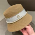 Detail shot of summer straw bucket hat with white ribbon, pearl trim and sparkly M logo. - M (56-58cm) / Khaki