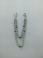 Detail view of a dual-strand 12mm rhinestone disco ball pants chain in silver and green. - Style 5