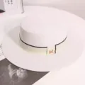 Elegant women summer flat top straw hat with ribbon detail and chic metal accent for beach holiday - One Size / White