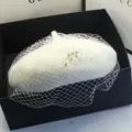 Close-up of vintage white wool beret with elegant mesh veil and crystal floral detail - Adjustable / Off White