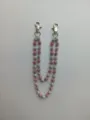 Detail of 12mm pink and silver rhinestone disco ball beads on a hip hop pant chain. - Style 20