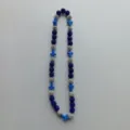 Detailed view of the blue and silver Shamballa rhinestone bead necklace with cross charms. - 10mm Beads, Approx 56 Beads, 54cm(21.25inch), 5 Rows / Style 15