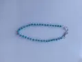 Close-up detail of the sparkling blue rhinestone ball pants chain with durable metal lobster clasps. - 10mm 5-Row Rhinestone Disco Balls / Color 13