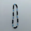 Detailed close-up of the beaded necklace featuring black, silver diamond, and blue cross charms. - 10mm Bead, 5 Rows Rhinestone, 54cm / Blue White Black with Cross