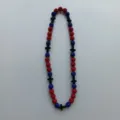 Close-up detail of the red and blue rhinestone shamballa beads necklace with black cross. - 10mm 5 Rows / Red Blue Black Cross Style