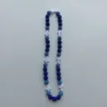 Close-up view of blue crystal rhinestone shamballa beads and white cross necklace details. - 10mm 5 Rows / Blue Cross Style