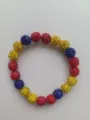 Detailed close-up of 10mm Shamballa beads with red, yellow and blue rhinestones - No.17