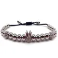 Close up of crown bead macrame bracelet details, cubic zirconia charm and metal beads. - Silver