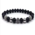 Close-up detail of a beaded bracelet featuring matte black beads, silver balls, and pave cubic zirconia. - Color 4