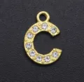 Close-up detail of gold-tone alloy rhinestone letter C charm, sparkling crystal pendant accessory. - Letter C / Gold