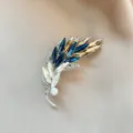 Exquisite crystal rhinestone feather brooch detail, featuring blue and champagne stones. - No. 1001