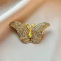 Exquisite crystal butterfly brooch, elegant gold-toned metal inlaid with sparkling rhinestones. - Butterfly Brooch / Gold