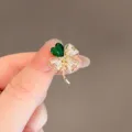 Elegant gold-plated four-leaf clover brooch pin with a vibrant green crystal leaf - Green Clover