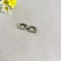 Detailed close-up of zinc alloy double ring belt accessory, premium hardware for apparel. - Silver Interlocking Buckle