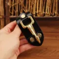 Leather key belt clip detail, durable brass metal hook and black leather buckle for daily use. - Black