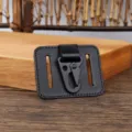 Close-up of black leather belt loop key holder featuring metal carabiner and dual slots. - Black