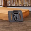 Detailed view of the black metal hook and genuine leather belt loop key holder in close up. - Coffee