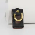 Close-up of handmade genuine leather waist hanging buckle featuring shiny gold D-ring. - Black
