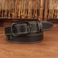 Detailed view of a women's dark leather belt featuring white stitching and floral embroidery - Black / 100cm