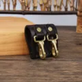 Leather belt key holder detail, durable brass hook and snap fastener for waist accessory. - Coffee