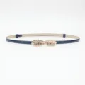 Elegant navy blue patent leather thin belt with gold leaf metal buckle, stylish accessory. - Blue