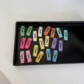 Colorful mini polka dot snap hair clips for babies and pets displayed on a black tray - Polka Dot Square Style