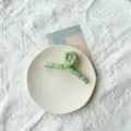 Elegant mint green fabric-wrapped hair claw clip for a minimalist summer look. - Green