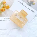 Minimalist hollow geometric hair claw clip in elegant translucent amber marble finish - Jelly Orange
