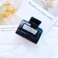 Minimalist black geometric hollow hair claw clip accessory in a stylish medium size. - Solid Black