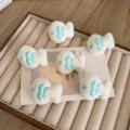 Cute white plush fish DIY accessories with cyan embroidery details for bags and clothes - Teal