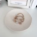 Elegant beige pearl bow elastic hair ties for women presented in a minimalist ceramic tray - Beige