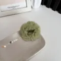 Olive green plush fuzzy scrunchie hair accessory displayed on a stylish ceramic tray - Grass Green