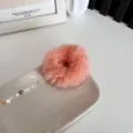 Soft fluffy plush scrunchie in coral pink finish for elegant autumn and winter hair styles - Orange