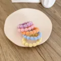 Set of five colorful textured bubble hair ties arranged on a white ceramic plate - 5 Pieces / Solid Color Bead Style