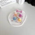 Lot de 4 mini pinces à cheveux pour enfants aux couleurs pastel orange violet bleu jaune - Petite Griffe / Lot de 4