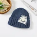 Blue winter knit beanie hat with cute patch detail, warm and stylish roll edge design for women. - One Size / Aqua