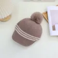 Detailed view of the Japanese style striped knitted hat with warm pom-pom and cozy fit. - Adjustable / Coffee